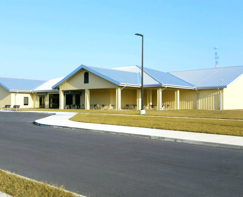 Community based outpatient clinic building with yellow walls and a silver metal roof